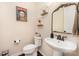 Charming powder room with pedestal sink, decorative mirror, and modern fixtures at 1126 Roderick Dr, Fort Mill, SC 29708