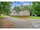 A gravel driveway leads to a cozy home with tidy landscaping and a storage shed at 1245 Forest Ridge Rd, Bessemer City, NC 28016