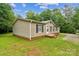 A view of the home's exterior, showing neat landscaping, and access to the front entry at 1245 Forest Ridge Rd, Bessemer City, NC 28016