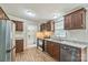 Modern kitchen featuring stainless steel appliances, wood cabinets, and hard surface countertops at 1245 Forest Ridge Rd, Bessemer City, NC 28016