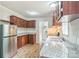 Well-lit kitchen featuring stainless steel appliances, wood cabinets and granite countertops at 1245 Forest Ridge Rd, Bessemer City, NC 28016