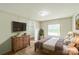 Relaxing primary bedroom features a large window, a dresser, and a queen sized bed at 1245 Forest Ridge Rd, Bessemer City, NC 28016