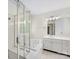 Bright bathroom with a glass enclosed shower and a soaking tub by the window at 12529 Old Timber Rd, Charlotte, NC 28269