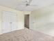 Carpeted bedroom featuring neutral walls, a ceiling fan, and double closets at 12529 Old Timber Rd, Charlotte, NC 28269