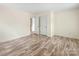 This bedroom offers hardwood floors, neutral walls, and ample space at 12529 Old Timber Rd, Charlotte, NC 28269