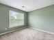Bedroom featuring neutral carpet, and a large window for natural light at 12529 Old Timber Rd, Charlotte, NC 28269