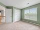 Bedroom with a large window and double door closet at 12529 Old Timber Rd, Charlotte, NC 28269