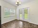 Bright dining area with backyard access, enhanced by an elegant chandelier at 12529 Old Timber Rd, Charlotte, NC 28269