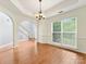Dining room with hardwood floors, crown molding, and large window with natural light at 12529 Old Timber Rd, Charlotte, NC 28269