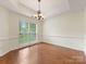 Dining room with hardwood floors and large window at 12529 Old Timber Rd, Charlotte, NC 28269