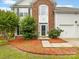 Close up of the house with brick facade, front door and landscaping at 12529 Old Timber Rd, Charlotte, NC 28269