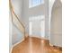 Inviting foyer features a hardwood floor, staircase, and arched doorway leading to other rooms at 12529 Old Timber Rd, Charlotte, NC 28269