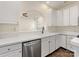 Kitchen featuring white cabinets, stainless steel dishwasher, and view into living room at 12529 Old Timber Rd, Charlotte, NC 28269