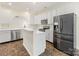 Kitchen featuring white cabinets, stainless steel appliances, and a breakfast bar at 12529 Old Timber Rd, Charlotte, NC 28269