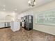 Open-concept kitchen and dining area featuring an island, stainless steel appliances, and generous natural light at 12529 Old Timber Rd, Charlotte, NC 28269