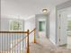 Second floor landing features carpet flooring and a large window for natural light at 12529 Old Timber Rd, Charlotte, NC 28269