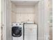 Laundry closet featuring a modern washing machine and a white dryer at 12529 Old Timber Rd, Charlotte, NC 28269