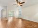 Open floor plan featuring hardwood floors, archways, and lots of natural light at 12529 Old Timber Rd, Charlotte, NC 28269