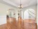 Bright living room with hardwood floors, fireplace, archways and staircase at 12529 Old Timber Rd, Charlotte, NC 28269