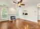 Living room featuring a fireplace, hardwood floors, and archway to kitchen at 12529 Old Timber Rd, Charlotte, NC 28269