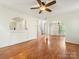 Open living room with hardwood floors, fireplace, and archway at 12529 Old Timber Rd, Charlotte, NC 28269