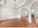 Spacious living room featuring an open floor plan, hardwood floors, and archways at 12529 Old Timber Rd, Charlotte, NC 28269