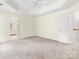 Spacious main bedroom features tray ceilings, carpet, and a bathroom at 12529 Old Timber Rd, Charlotte, NC 28269