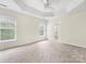 Spacious main bedroom features tray ceilings, carpet, and large windows for natural light at 12529 Old Timber Rd, Charlotte, NC 28269