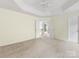 Spacious main bedroom with tray ceiling, neutral carpet, and double door entry at 12529 Old Timber Rd, Charlotte, NC 28269