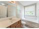This primary bathroom features a large bathtub and a wood vanity sink at 13413 Golden Apple Ct, Charlotte, NC 28215