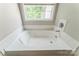 Cozy bathtub nook with a window that fills the space with bright light at 13413 Golden Apple Ct, Charlotte, NC 28215