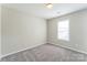 This bedroom features neutral walls, soft carpet, and a bright window at 13413 Golden Apple Ct, Charlotte, NC 28215