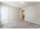 This bedroom has soft carpet and a doorway that leads to the bathroom at 13413 Golden Apple Ct, Charlotte, NC 28215