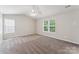 Spacious bedroom featuring a ceiling fan, plush carpet, and natural light from two windows at 13413 Golden Apple Ct, Charlotte, NC 28215