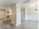 The dining room features gray wood floors, a chandelier and a view of the kitchen at 13413 Golden Apple Ct, Charlotte, NC 28215