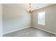 Elegant dining room with laminate flooring and a decorative chandelier above at 13413 Golden Apple Ct, Charlotte, NC 28215