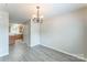 Spacious dining area flows into the kitchen with an elegant chandelier at 13413 Golden Apple Ct, Charlotte, NC 28215