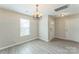 Open entryway area featuring stylish lighting and beautiful vinyl flooring at 13413 Golden Apple Ct, Charlotte, NC 28215
