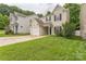 Charming two-story home with a well-maintained lawn and a single-car garage at 13413 Golden Apple Ct, Charlotte, NC 28215