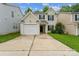 Charming two-story home featuring a white garage door, black shutters and a well-maintained front yard at 13413 Golden Apple Ct, Charlotte, NC 28215