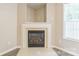 A fireplace featuring a white marble hearth with wooden logs at 13413 Golden Apple Ct, Charlotte, NC 28215