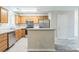 A kitchen featuring wood cabinets, stainless steel appliances, and gray countertop island at 13413 Golden Apple Ct, Charlotte, NC 28215