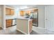 A kitchen featuring wood cabinetry, stainless steel appliances, and an island bar at 13413 Golden Apple Ct, Charlotte, NC 28215