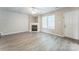Comfortable living room with fireplace, neutral walls, and light wood-look flooring at 13413 Golden Apple Ct, Charlotte, NC 28215