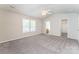 Primary bedroom with ceiling fan, carpet, and ensuite bathroom with tiled floor at 13413 Golden Apple Ct, Charlotte, NC 28215