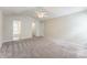 Primary bedroom featuring a ceiling fan, plush carpet, and ensuite bath at 13413 Golden Apple Ct, Charlotte, NC 28215