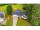 Aerial view of home featuring pool, garage, lawn, and driveway at 1377 Beagle Run, Salisbury, NC 28146