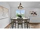 Bright dining room featuring a large window, chandelier and an inviting dining table at 1377 Beagle Run, Salisbury, NC 28146
