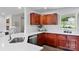 Charming kitchen boasts stainless steel appliances, wooden cabinets, and bright countertops at 1377 Beagle Run, Salisbury, NC 28146