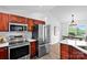 Modern kitchen with stainless steel appliances, hardwood floors, and bright white countertops at 1377 Beagle Run, Salisbury, NC 28146